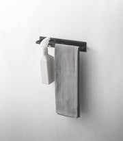 Yamazaki Home - Magnetic Kitchen Towel Hanger - Steel: White, wall-mounted with a hook holding a spray bottle and a bar with a light gray towel.