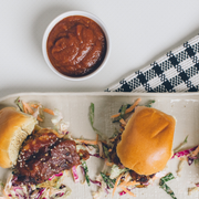 Beth's Farm Kitchen - Farm Ketchup - Low Sugar featured with sliders and ramekin of sauce, highlighting its use with barbecue-glazed protein and slaw, perfect for sliders.