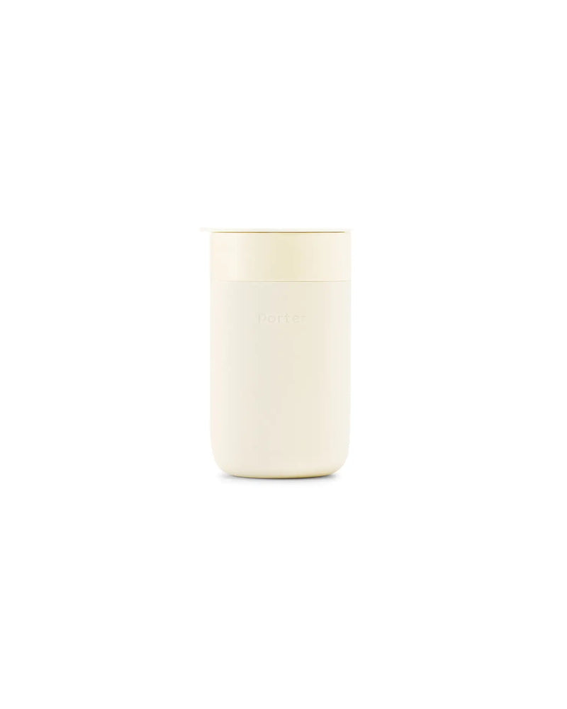 Reusable Ceramic Mug: Terrazzo Blush, 16 oz, with a white lid, featuring a splash-resistant slide-lock tab and silicone sleeve for grip.