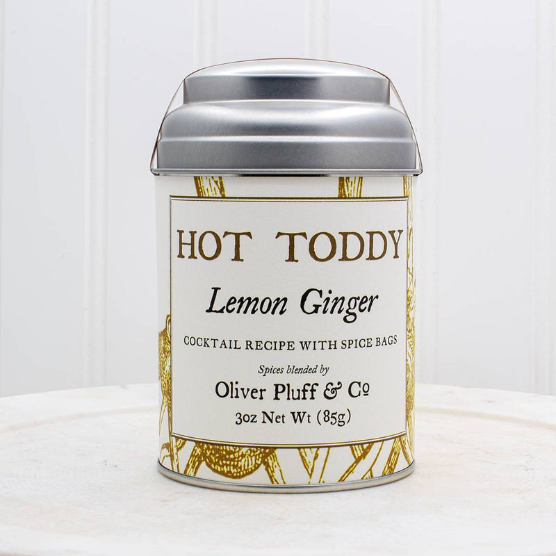 Oliver Pluff & Company - Lemon Ginger Hot Toddy Kit: Small tin with spices for making lemon-ginger hot toddy cocktails, including cinnamon sticks, lemongrass, and ginger.