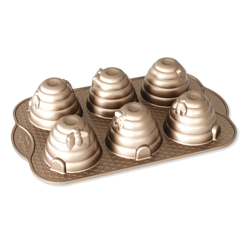 Nordic Ware Beehive Cakelet Pan with beehive-shaped molds for baking mini cakes, featuring a non-stick surface for easy release.