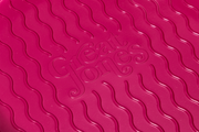 Great Jones | Patty Cake - Broccoli with a wavy, corrugated design, ideal for easy release and even baking, showcased in a close-up of its textured surface.