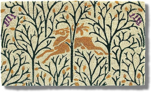 Entryways | Victoria and Albert Museum Doormat, Deer in the Forest, 18 x 30: A woodland-themed coir mat depicting a leaping deer amid stylized trees and leaves.