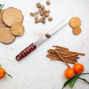 Microplane Premium Zester, Grater - UGA Plaid with nutmeg, cinnamon sticks, tangerines, and wood slices on marble; ideal for zesting and grating spices.