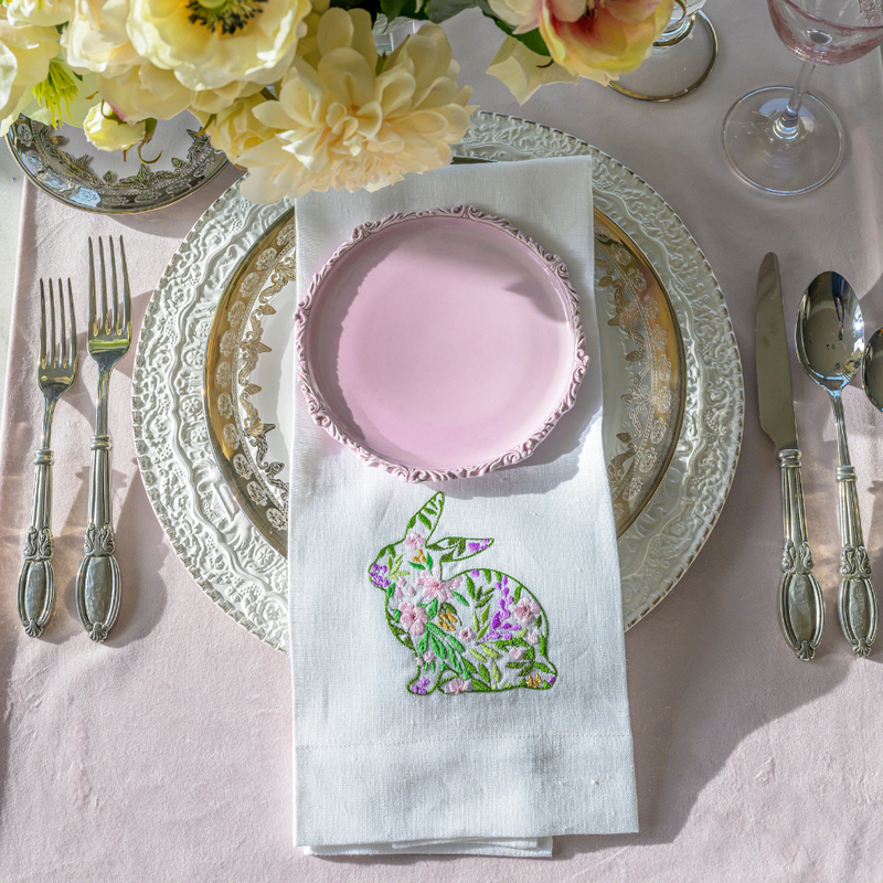 Garden Bunny Linen Towel with embroidered floral bunny on display within an elegant table setting, featuring flowers and a silver knife, ideal for festive home decor.