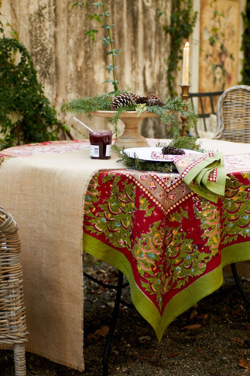 Couleur Nature - Noel Red & Green French Tablecloth, 71 x 71, displayed with rustic table setting, featuring evergreen sprigs, pinecones, and festive decor.