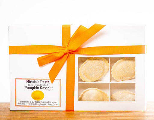 Nicola's Marketplace - Pumpkin Ravioli: 24-count, handcrafted, visible through a window in a white gift box with orange ribbon, ready to simmer in salted water.