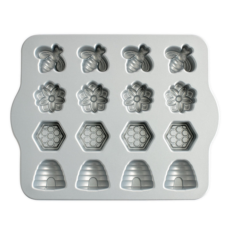Nordic Ware | Busy Bee Bitelet Pan featuring 16 bee and flower-shaped cavities for creating festive, bite-sized treats, perfect for spring and summer occasions.