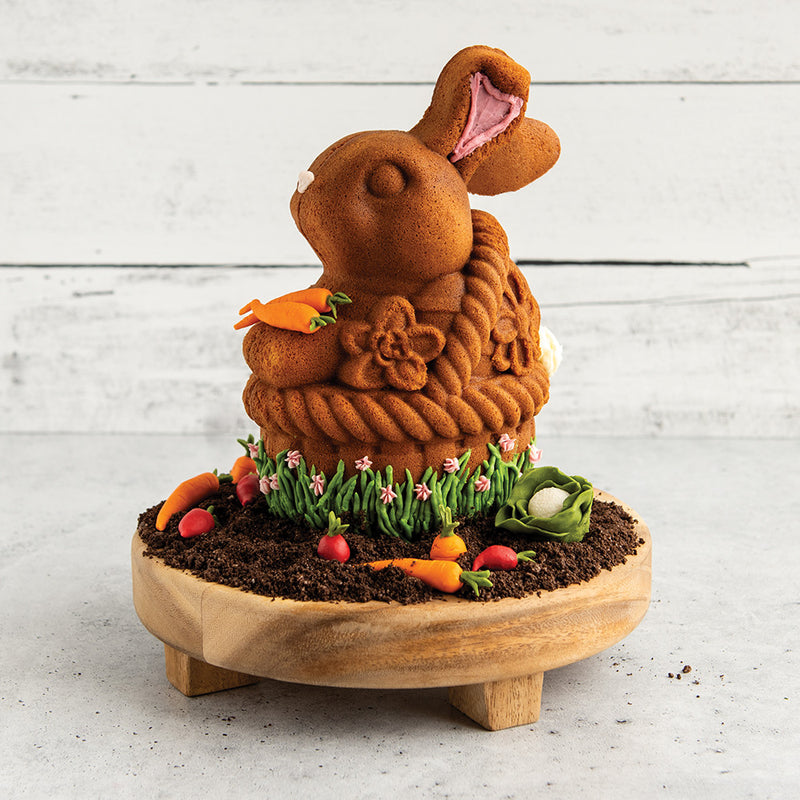 Nordic Ware | Bunny In Basket 3D Cake Pan showcasing a crafted bunny-shaped cake with carrot decorations, highlighting its intricate design for Easter baking.