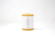 Mo&Co Home - 100% Beeswax Pillar Candle, Natural Gold, 3x6 Inch, featuring a white label with black text, showcasing eco-conscious and hand-poured craftsmanship.