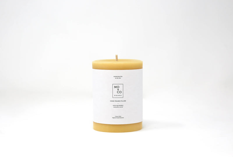 Mo&Co Home - 100% Beeswax Pillar Candle, Natural Gold, 3x6 Inch, featuring a white label with black text, showcasing eco-conscious and hand-poured craftsmanship.
