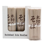 Mikuni Wild Harvest USA - Buckwheat Soba Noodles, 250g: Bundles of uncooked noodles in clear packaging with Japanese text, displayed in a labeled white tray.