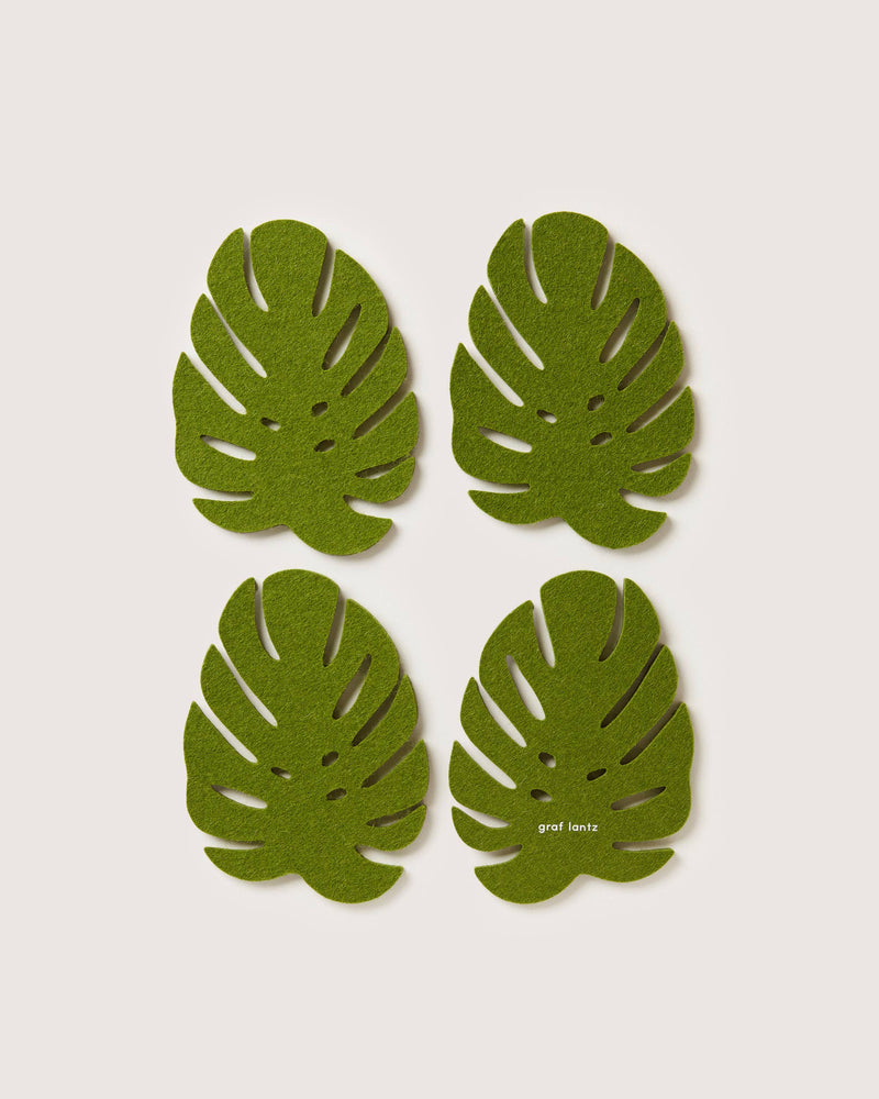 Graf Lantz Merino Wool Monstera Coaster Set, featuring intricate green leaf designs, adds organic elegance to any table setting.