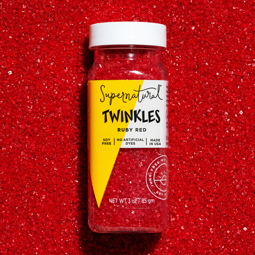 Supernatural - Twinkles Sanding Sugar: Ruby Red in a clear jar, nestled in matching sugar crystals, ideal for enhancing baked goods or drinks with vibrant, edible sparkle.