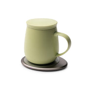 OHOM - Ui 3 Self-heating Mug Set: Jasmine White on an electronic coaster, indicating it's powered on, ideal for maintaining beverage temperature and wirelessly charging devices.