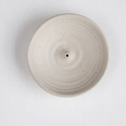 Gravesco Pottery - Incense Burner, a round, ridged off-white ceramic dish with a central hole, designed to catch incense ash gracefully.