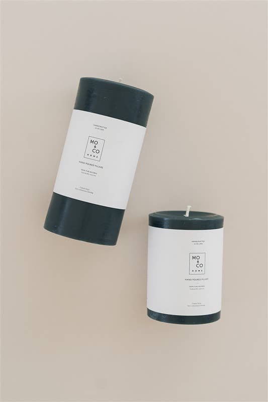 Mo&Co Home - Forest Green Beeswax Pillar Candle, 100% Natural, Handmade, 3x6 Inch. Two candles, one standing, one tilted; elegant decor for gatherings.