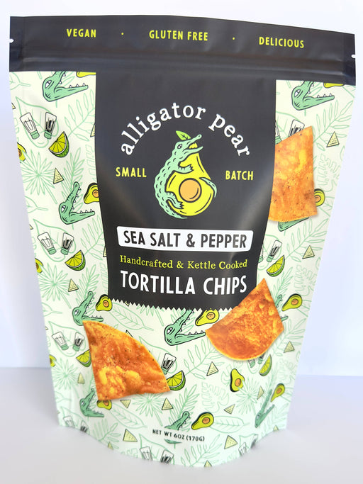 Alligator Pear Foods - Sea Salt & Pepper tortilla chips, 6oz bag featuring a cartoon crocodile and labeled as gluten-free, perfect for pairing with dips.