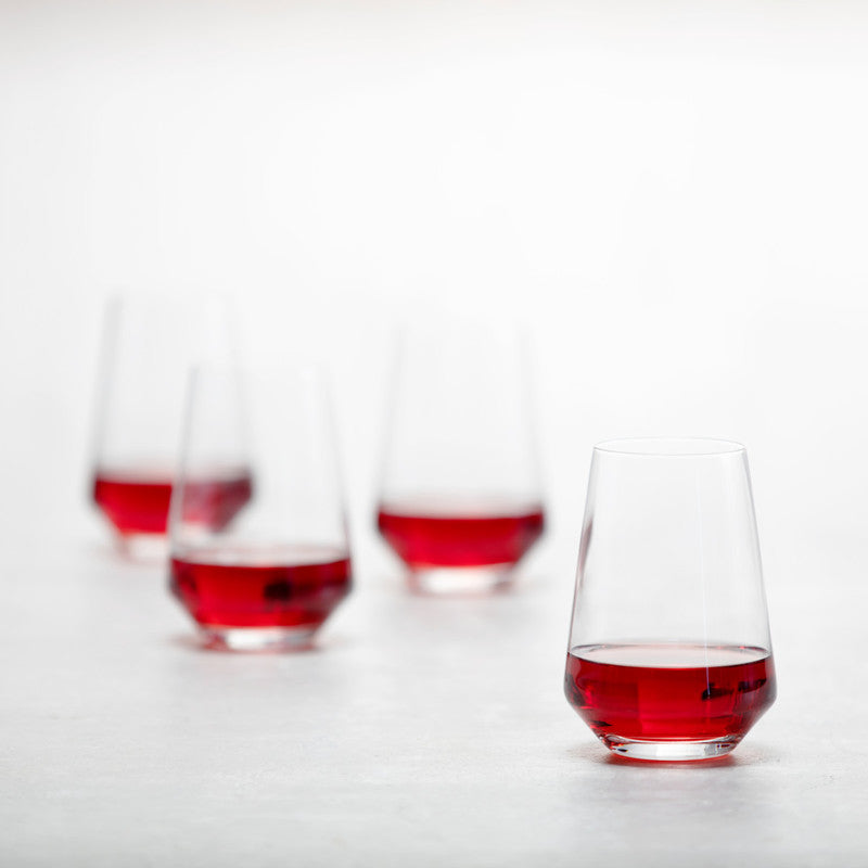 Zwiesel Fortessa | Pure Stemless Wine Tumbler, 18.5 oz, showcasing elegant postmodern design, with four glasses partially filled with deep red liquid on display.