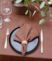 Set of 2 MagicLinen napkins, elegantly folded on a plate, ideal for enhancing table decor with their premium linen texture.