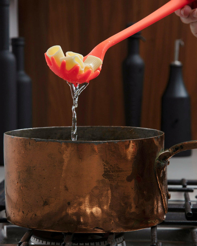 GIR Get It Right - GIR Spaghetti Spoon: Navy, shown in use with pasta, highlighting its seamless, hygienic design for efficient scooping in a copper pot.