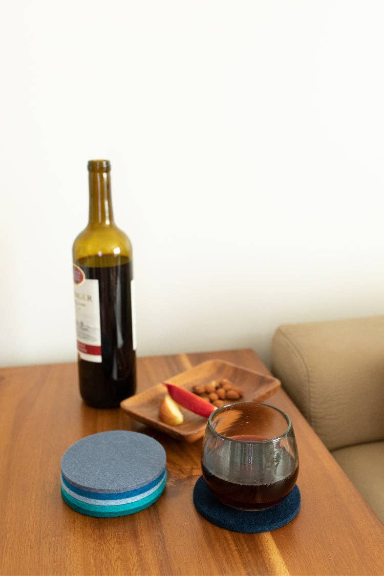 Graf Lantz - Bierfilzl Merino Wool Felt Round Coaster Multi 6 Pack: Ocean displayed with a wine glass and bottle on a table, showing their elegant design.