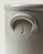 Farmhouse Pottery Agrarian Crocks - 1 Gallon - Stone with hand-stamped volume on handle, featuring a textured exterior with iron flecking for visual depth.