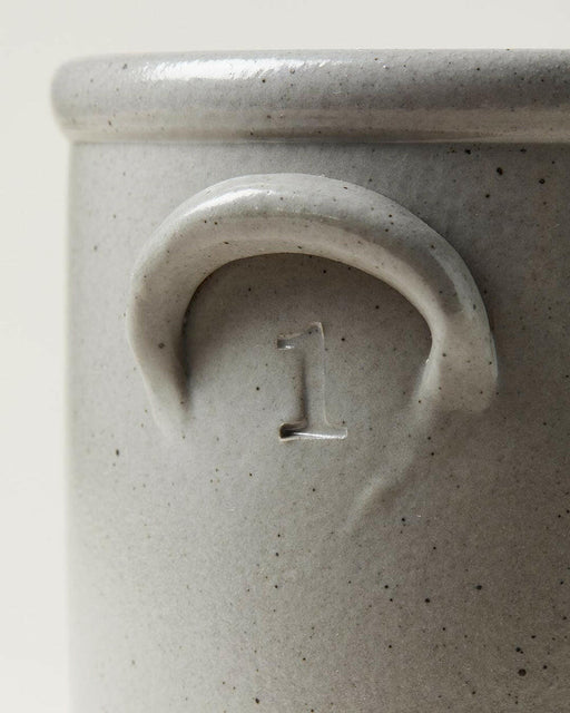 Farmhouse Pottery Agrarian Crocks - 1 Gallon - Stone with hand-stamped volume on handle, featuring a textured exterior with iron flecking for visual depth.