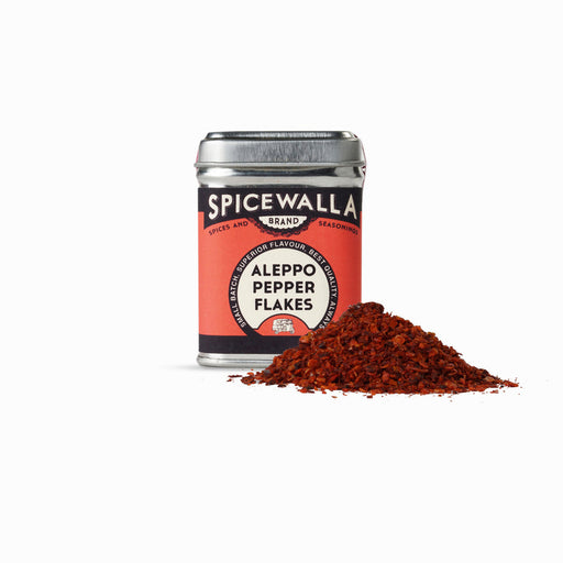Spicewalla | Aleppo Pepper Flakes tin with spilled reddish flakes, highlighting its nuanced flavor profile—ideal for adding mild heat to dishes.