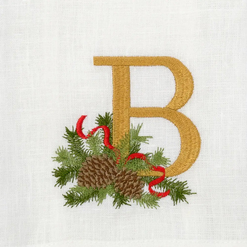 Arte Italica & Crown Linen Designs | Winter Pine Monogram Towel, B, White (Multi) features a gold embroidered B with festive pine and ribbon embellishments, perfect for holiday decor.