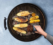 WOW GEAR | Gripmitt - Green in use, showcasing its versatility and safety while grilling corn and zucchini. Ideal for handling hot foods effortlessly.