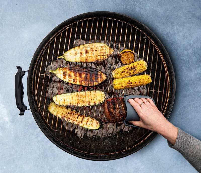 WOW GEAR | Gripmitt - Green in use, showcasing its versatility and safety while grilling corn and zucchini. Ideal for handling hot foods effortlessly.