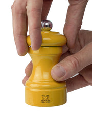 Peugeot | Bistro Salt Mill, Saffron, being twisted open, showcasing its elegant design and craftsmanship, ideal for enhancing kitchen aesthetics.