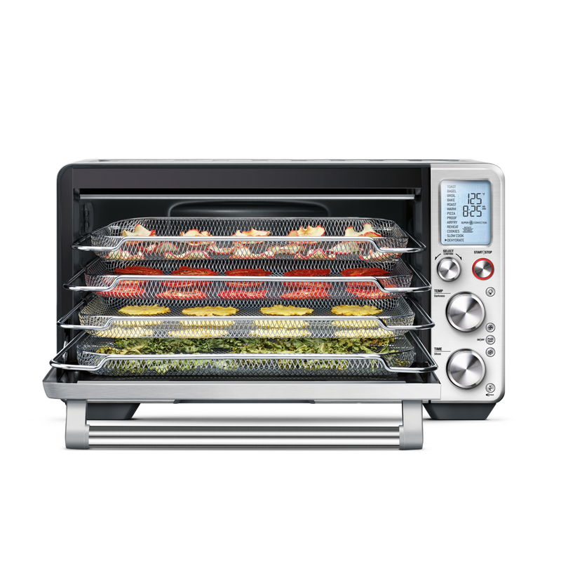 Breville | Smart Oven Air Fryer Pro with mesh trays for dehydrating produce. Digital display shows 125°F and 8:25 runtime, with temperature and time controls visible.