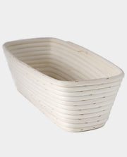 Breadtopia | Oblong Rattan Bread Proofing Basket and Liner: A coiled rattan basket for shaping dough, reflecting quality craftsmanship by the Nguyen family in Vietnam.