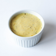 Banner Butter - Smoked Sea Salt in a white bowl, showcasing its creamy texture. Perfect for enhancing grilled dishes with its savory, smoky flavor.