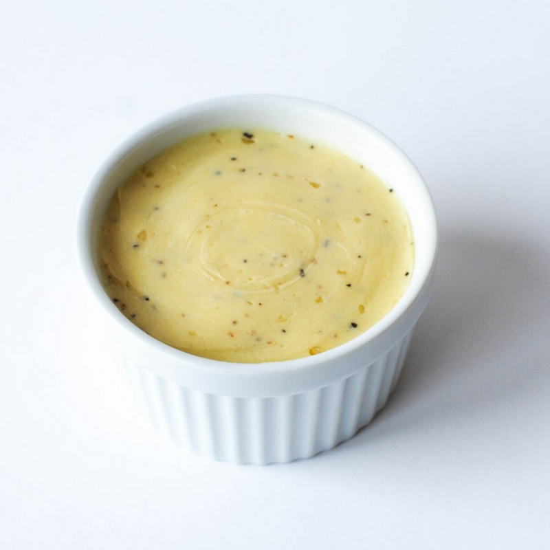 Banner Butter - Smoked Sea Salt in a white bowl, showcasing its creamy texture. Perfect for enhancing grilled dishes with its savory, smoky flavor.