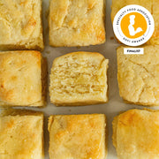 Callie's Hot Little Biscuit | Frozen Biscuits - Cheese + Chive, close-up of savory, handmade biscuit with cheddar and chives, showcasing its rich texture and artisanal quality.