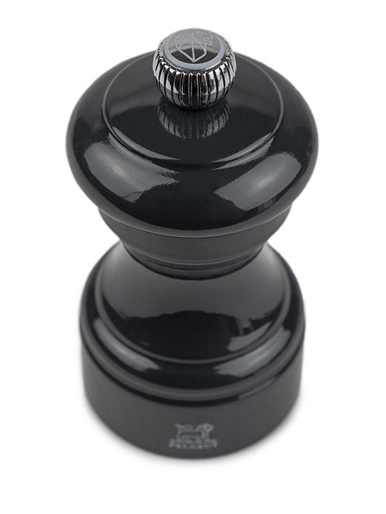 Peugeot | Bistro Salt Mill, Slate with a glossy black, turned-wood body and adjustable metal top knob for grind size, embodying timeless elegance and high performance.