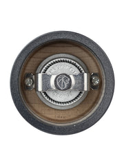 Close-up of Peugeot | Bistro Pepper Mill 4 Inches, showcasing the metal burr and adjustment knob within the wooden body, featuring the Peugeot France logo.