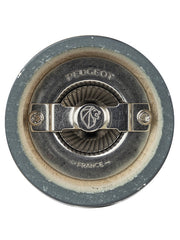 Close-up of Peugeot | Bistro Salt Mill, Slate's grinding mechanism, featuring a central adjustment screw and fluted wheel, marked “PEUGEOT FRANCE” for high-performance dry salt grinding.