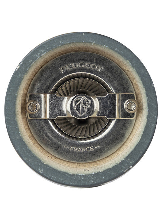 Close-up of Peugeot | Bistro Salt Mill, Slate's grinding mechanism, featuring a central adjustment screw and fluted wheel, marked “PEUGEOT FRANCE” for high-performance dry salt grinding.