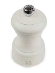 Peugeot | Bistro Pepper Mill, Ivory: A classic hourglass-shaped wooden mill with a top knob for adjusting pepper coarseness, crafted in France with a lifetime-guaranteed mechanism.