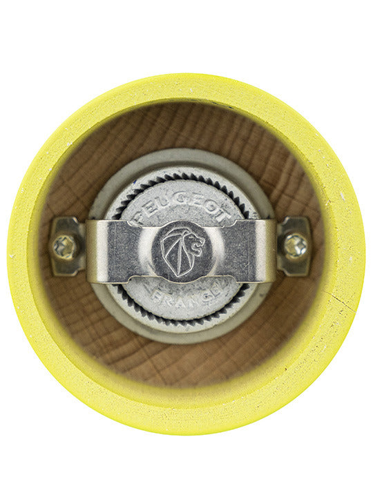 Peugeot | Bistro Pepper Mill, Green Pistachio, featuring a durable steel grinding mechanism engraved with Peugeot France and lion logo, inside a yellow-painted mill body.
