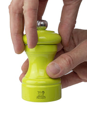 Peugeot | Bistro Pepper Mill in Green Pistachio, held in hands, showcasing its elegant French design and durable steel mechanism, perfect for culinary enthusiasts.