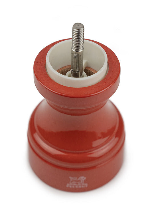 Peugeot | Bistro Salt Mill, Terracotta, with a visible ceramic and metal grinding mechanism, showcasing its glossy red beech wood design, ideal for French-style café ambiance.