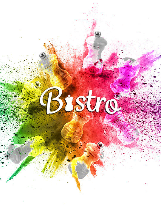 Stylized graphic featuring Bistro with Peugeot | Bistro Pepper Mill, Ivory, surrounded by vibrant powders, symbolizing flavor and modern casual dining.