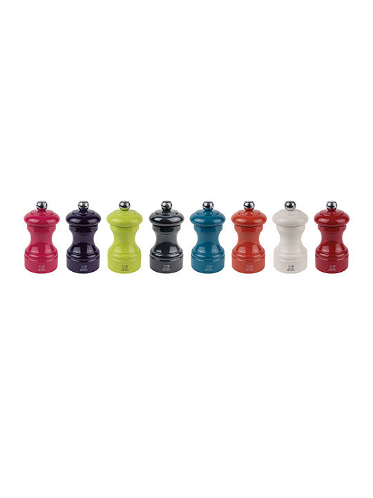 Peugeot | Bistro Pepper Mill 4 Inches, Slate Grey, part of a colorful display of classic hourglass-shaped spice mills with adjustable metal knobs, reflecting timeless elegance.
