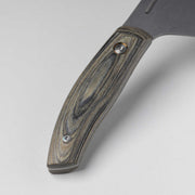Messermeister | Bunka 8 Chef's Knife handle close-up, showcasing wood-grain scales, metal fasteners, and part of the blade tang, emphasizing craftsmanship and ergonomic design.