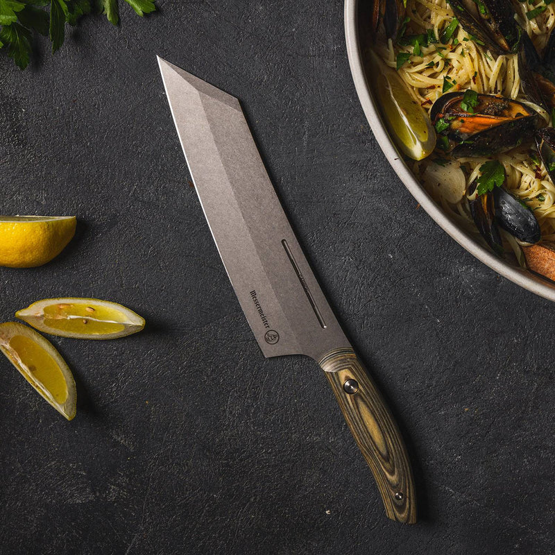 Messermeister | Bunka 8 Chef's Knife displayed on a slate surface with lemon wedges and parsley, highlighting its stonewashed blade and wood-grain handle.